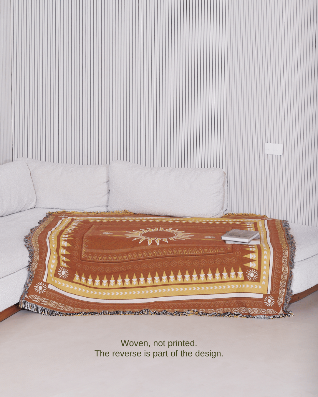 Sunset Brown blanket on sofa – woven, not printed