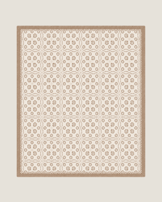 Terra Versatile Quilt in Sandstone, a neutral organic cotton quilt used as the base layer on a bed